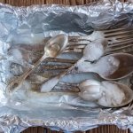 Cupronickel silver spoons and forks with baking soda in foil