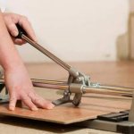 Cutting tiles with a manual tile cutter